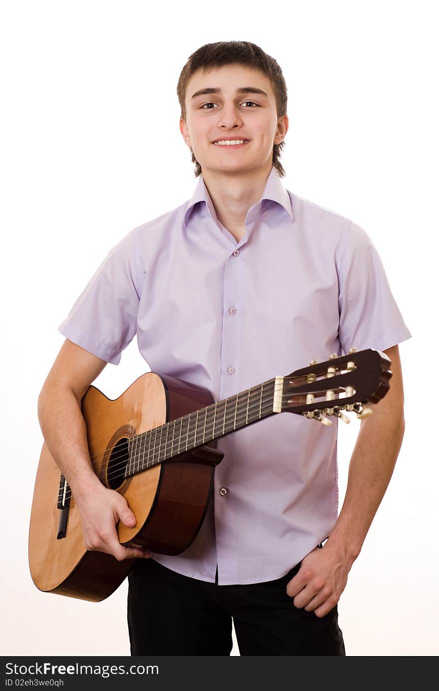 Handsome young student with a guitar on a white background