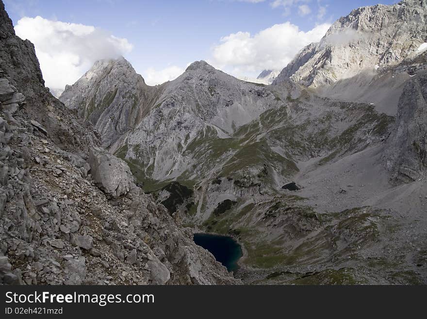 Photo is taken from the ridge between 2 peaks of Dragonkopf. On the back: Tajakopf peak and Dragonsee lake, Ehrwald, Tirol