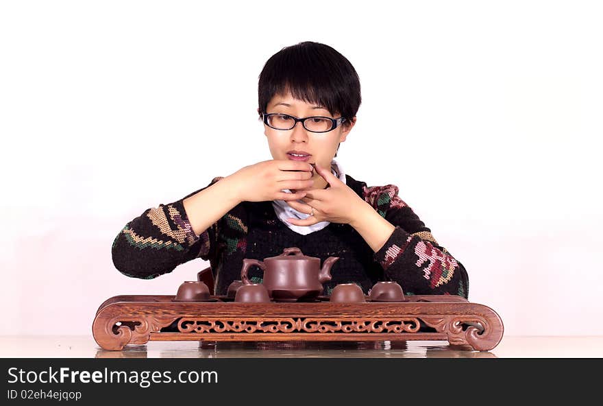 Chinese woman pours and drinks red tea. Chinese woman pours and drinks red tea.