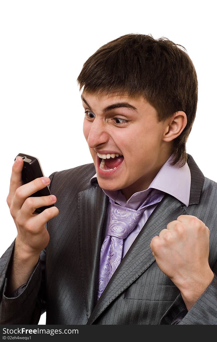 Angry young businessman talking on the phone on a white background