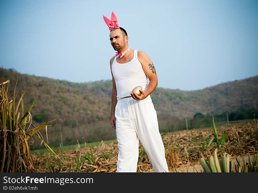 Man Wearing Bunny Hat Walking Across The Field. Man Wearing Bunny Hat Walking Across The Field