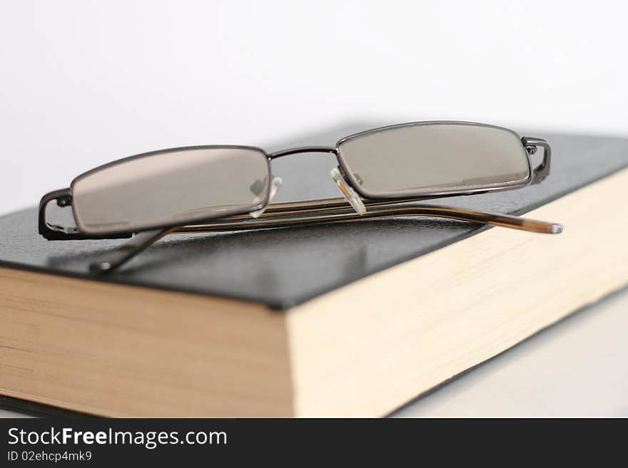 Book and Glasses isolated on white