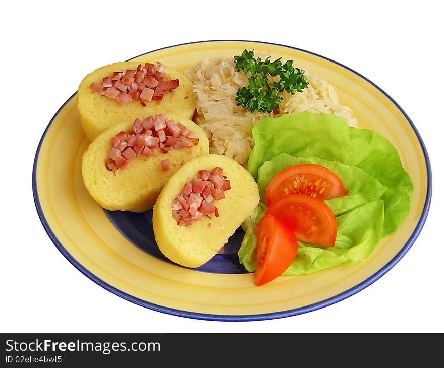 Plate of dumplings stuffed with meat and sauerkraut decorated with vegetables. Plate of dumplings stuffed with meat and sauerkraut decorated with vegetables