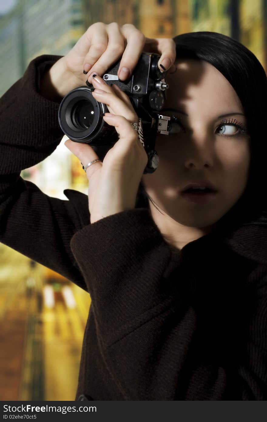 Woman holding up a retro camera about to take a photo. Woman holding up a retro camera about to take a photo.