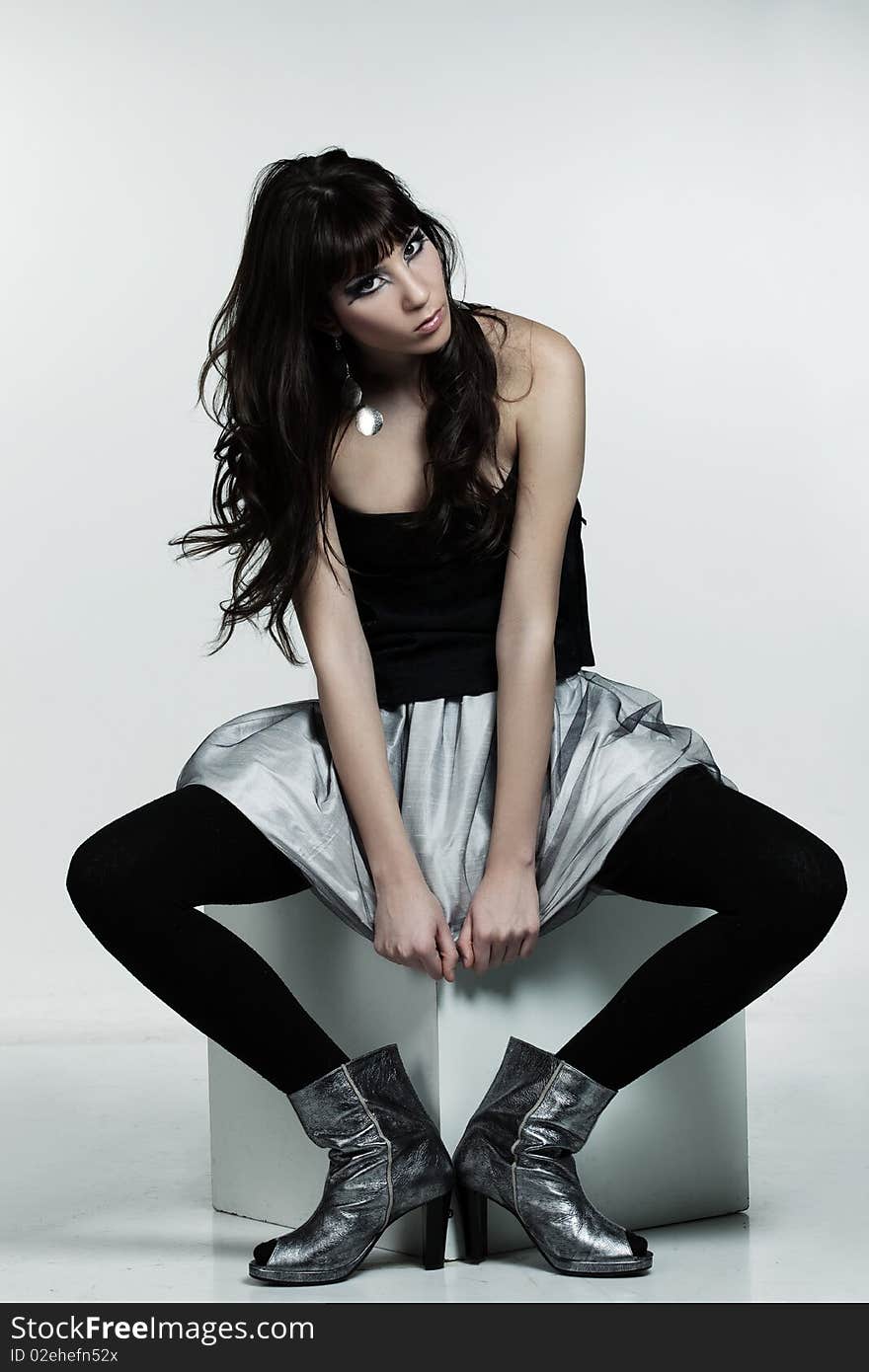 Young woman with strong make-up sitting down. Young woman with strong make-up sitting down