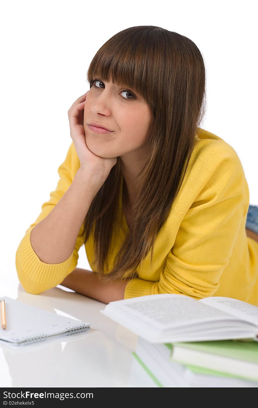 Student - Happy female teenager write homework with book on white background. Student - Happy female teenager write homework with book on white background