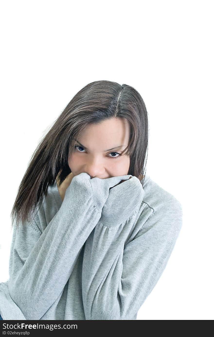 Young woman smiles shyly behind her hands. Young woman smiles shyly behind her hands.