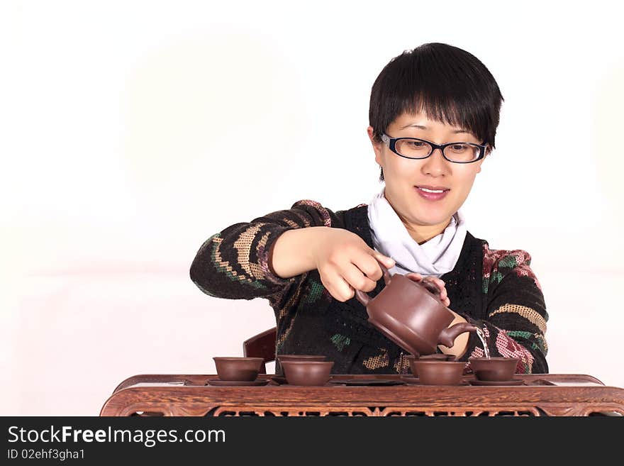 Woman pours and drinks red tea. Woman pours and drinks red tea.