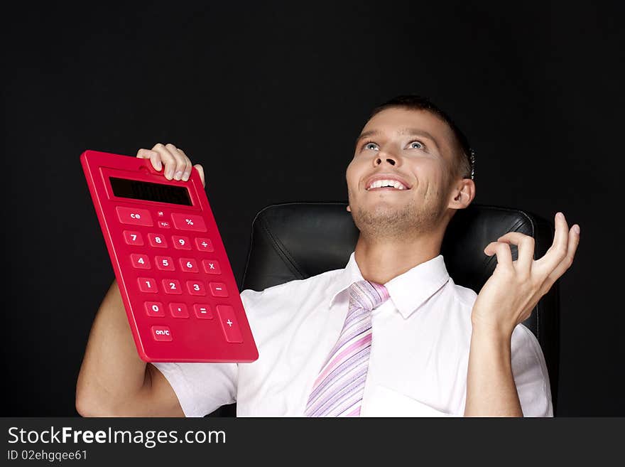 Handsome businessman with red calculator. Handsome businessman with red calculator