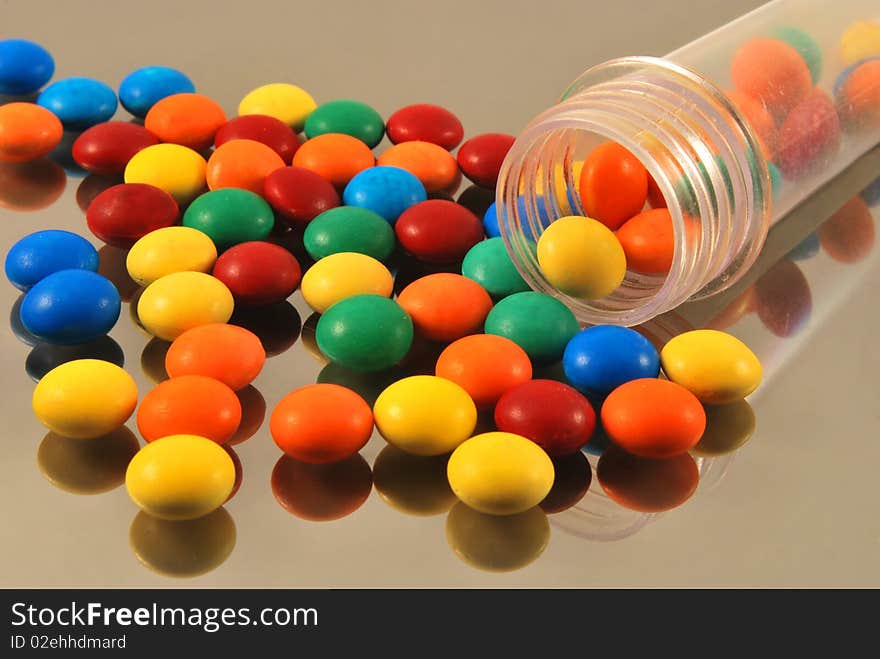 Colorful round candies on glass. Colorful round candies on glass