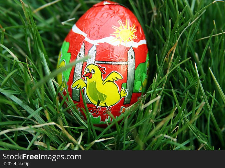 Chocolate egg placed in the grass so children can look for it. Chocolate egg placed in the grass so children can look for it