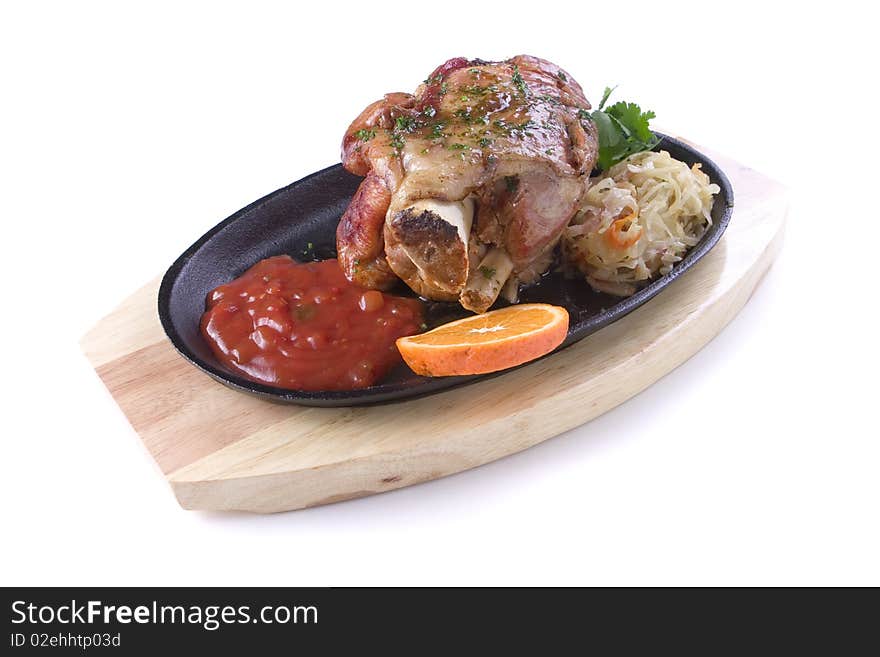 Meat with sauerkraut and sauce in pan on white ground