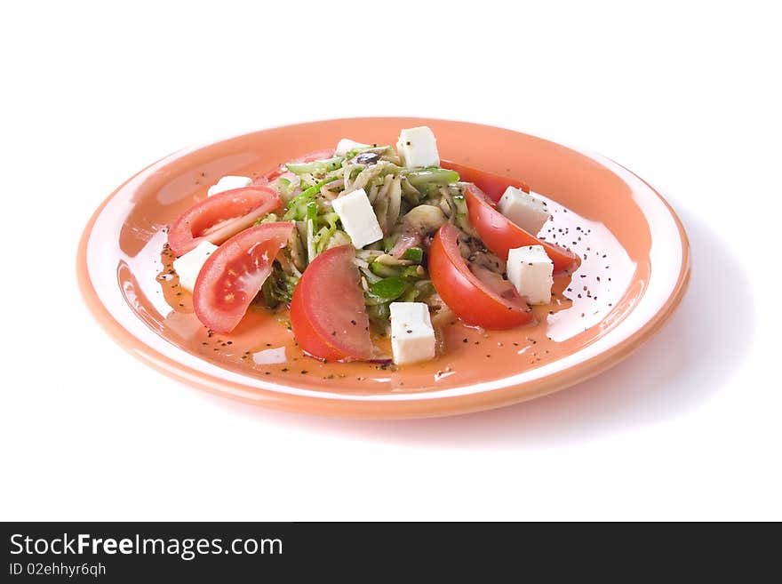 Fresh salad with mozarella and tomatoes on orange plate