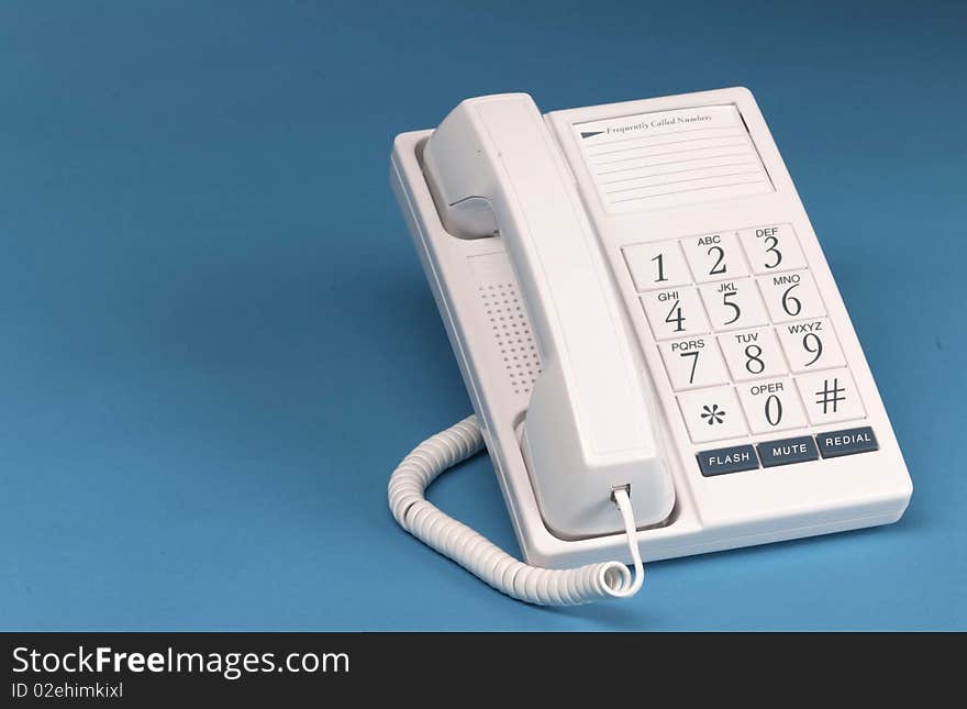 White phone on hook with big numbers sits on blue background. White phone on hook with big numbers sits on blue background