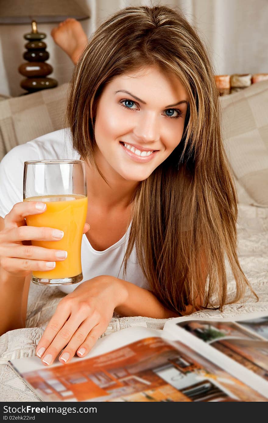 Young Beauty Woman With A Glass Of Orange Juice