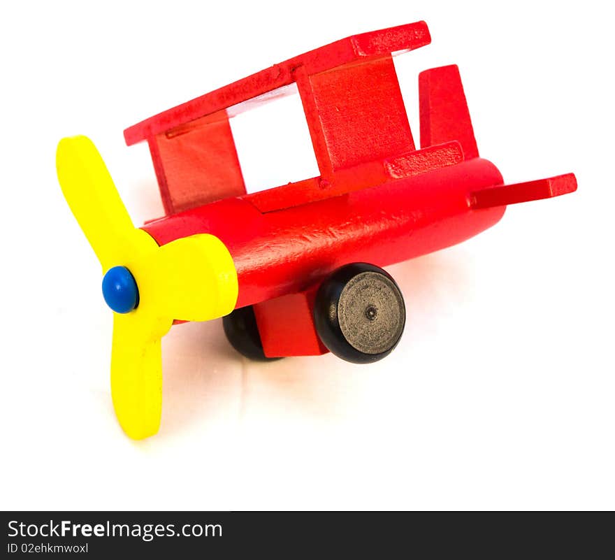 Wooden red toy airplane on a white background that is suitable for a young child. Wooden red toy airplane on a white background that is suitable for a young child.