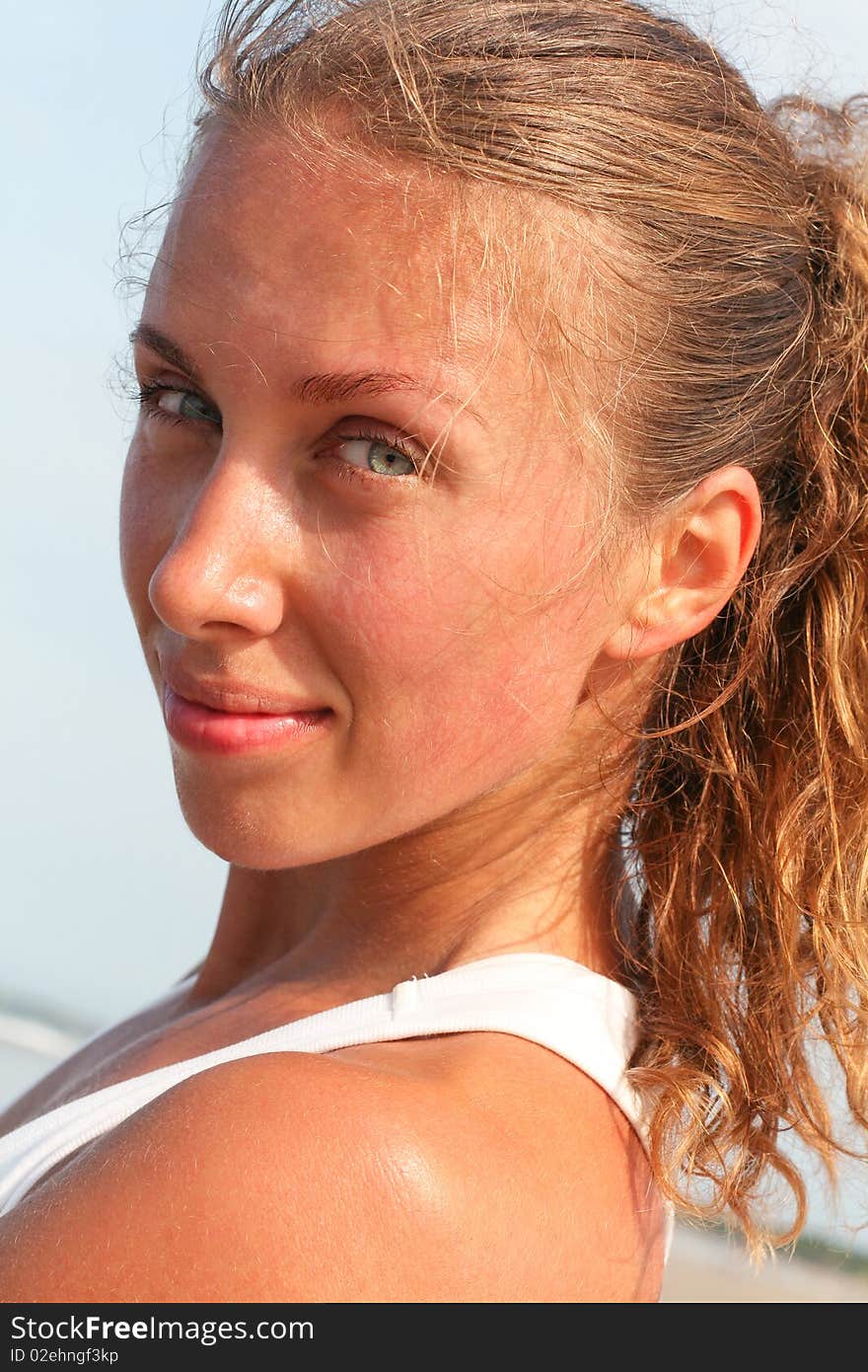 Photo of nice girl against the sky that looks into the camera