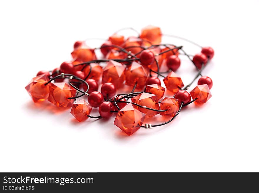 Red glass beads of the unusual form on white background. Red glass beads of the unusual form on white background