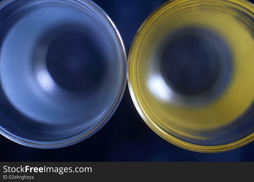 Two glass isolated on dark blue background. Two glass isolated on dark blue background