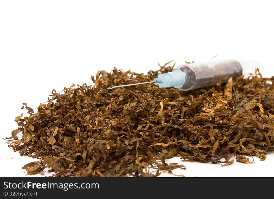 Abstract Smoking Addiction concept of pile of shredded tobacco with hypodermic needle. Abstract Smoking Addiction concept of pile of shredded tobacco with hypodermic needle.