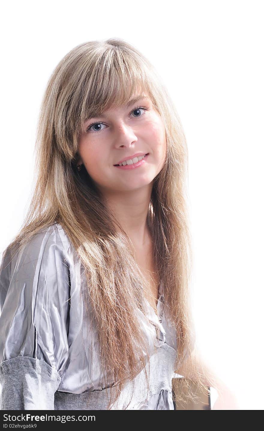 The young beautiful girl with a fair hair in a grey dress separately on a white background