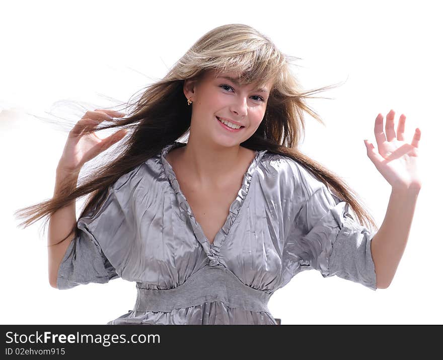 The young beautiful girl with a fair hair in a grey dress separately on a white background