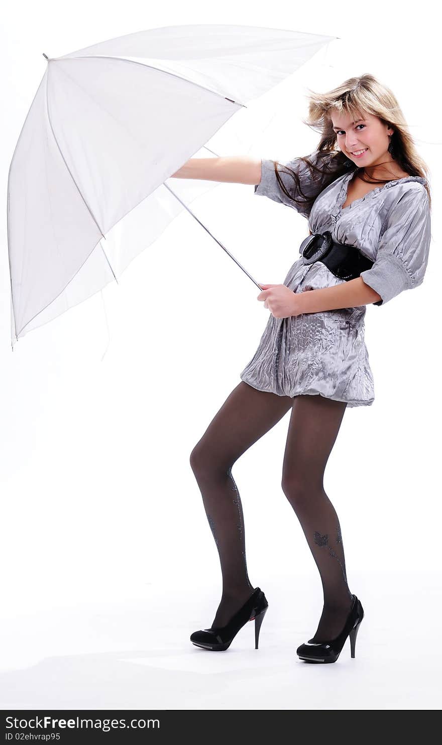 The young beautiful girl with a fair hair in a grey dress separately on a white background