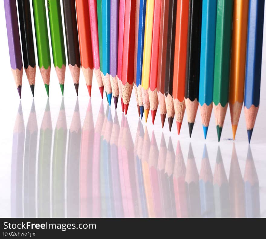 Color pencils in arrange in color wheel colors on white background