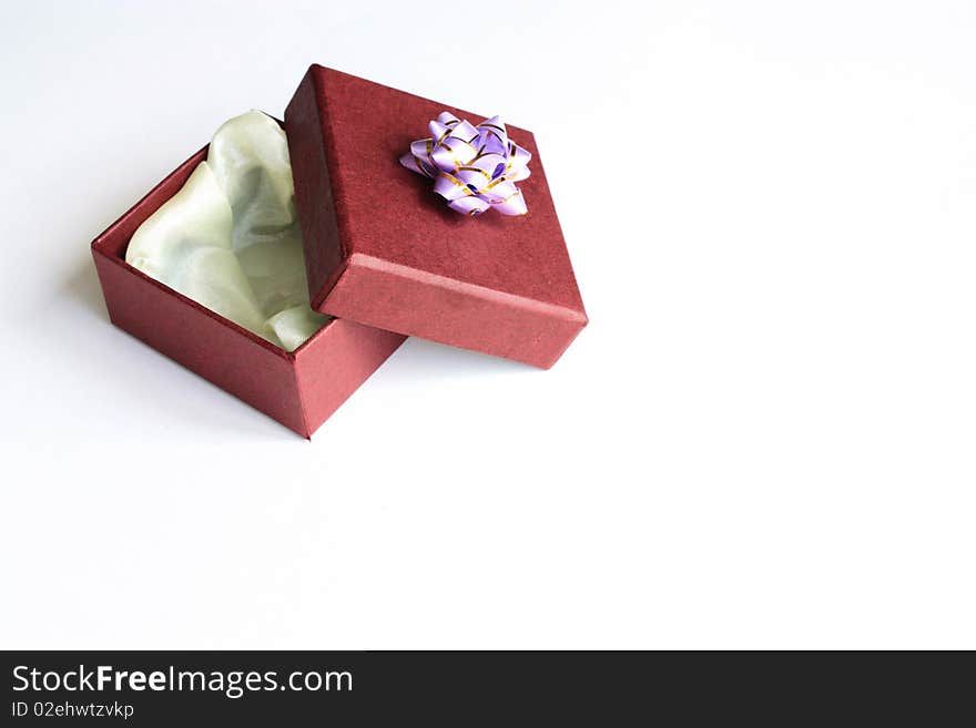 Present box with bright bow on white background