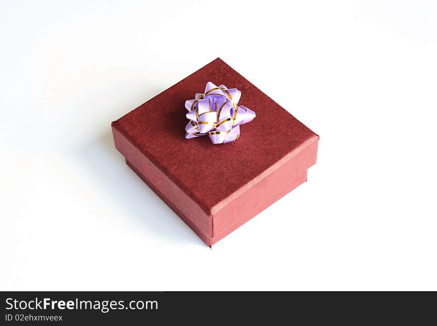 Present box with bright bow on white background