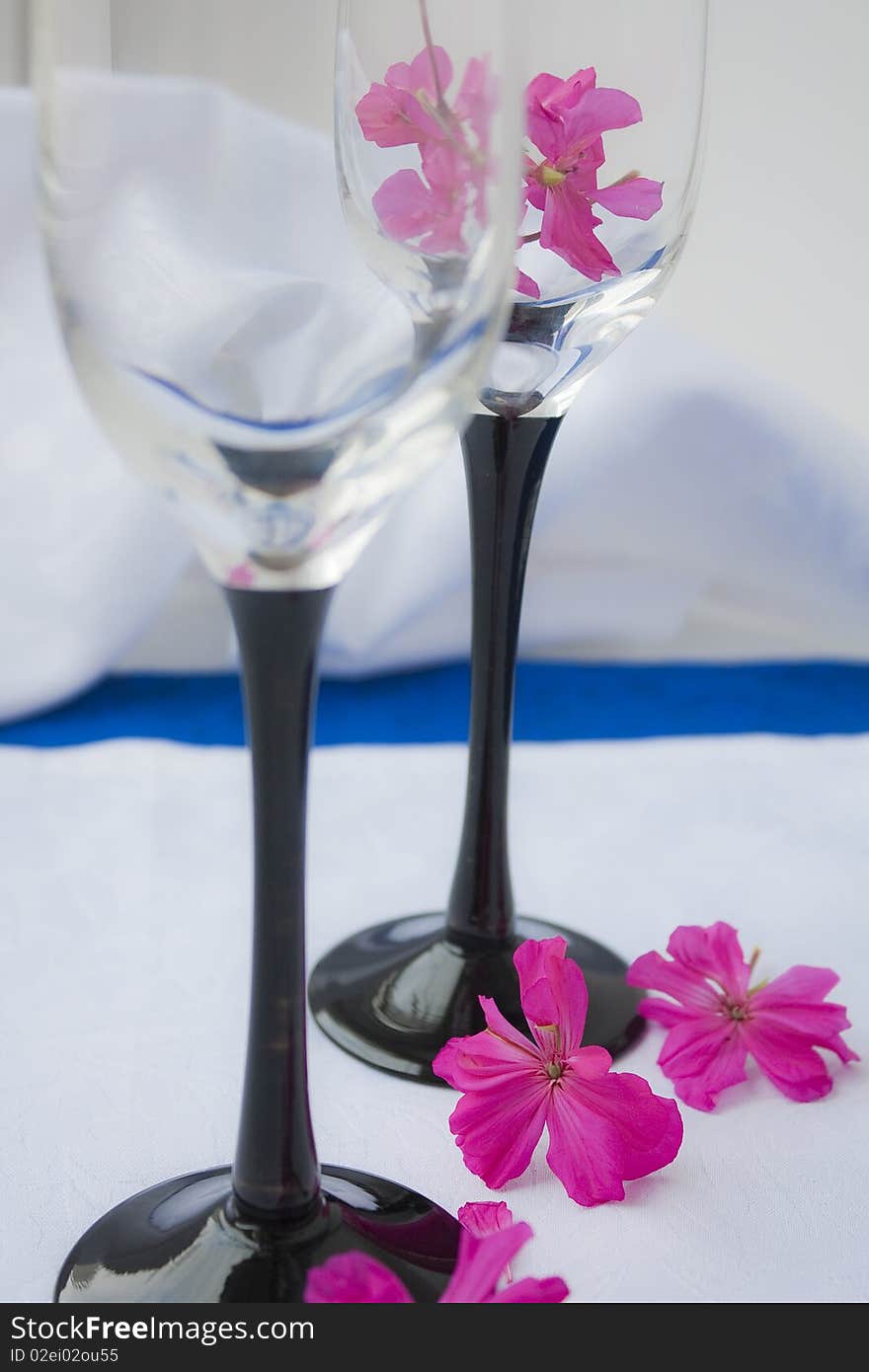 Two empty wine glasses costing on a white cloth