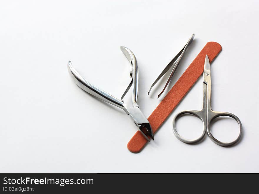 Steel tools for manicure on white background