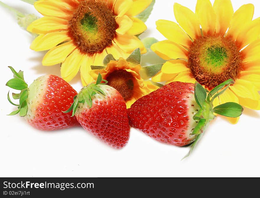 Fresh strawberries with sunflowers isolated on white background