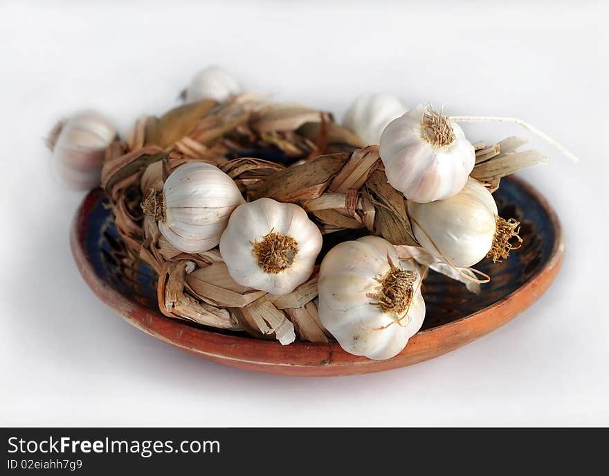 Rope of garlic on a clay plate