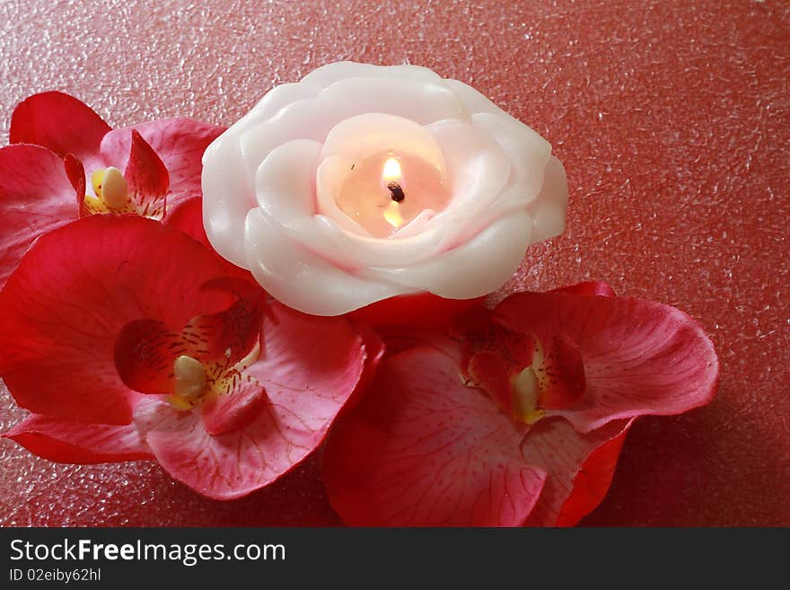 A spa items composition with flowers and candle.