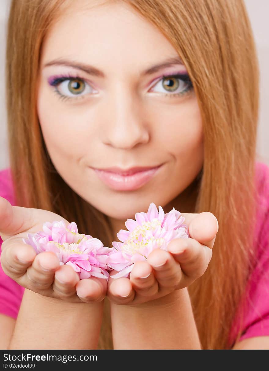 Young pretty girl holding two flowers. Young pretty girl holding two flowers