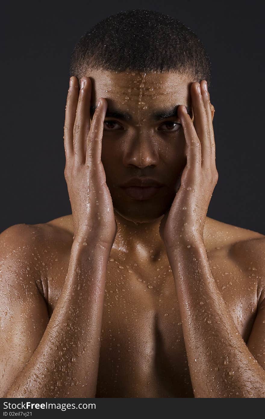 Drops of the water on naked body of a young man on black background. Drops of the water on naked body of a young man on black background.