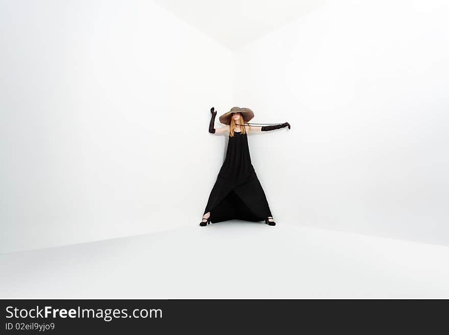 Portrait of a beautiful girl in elegant black dress and a  hat. Isolated over white background. Portrait of a beautiful girl in elegant black dress and a  hat. Isolated over white background.