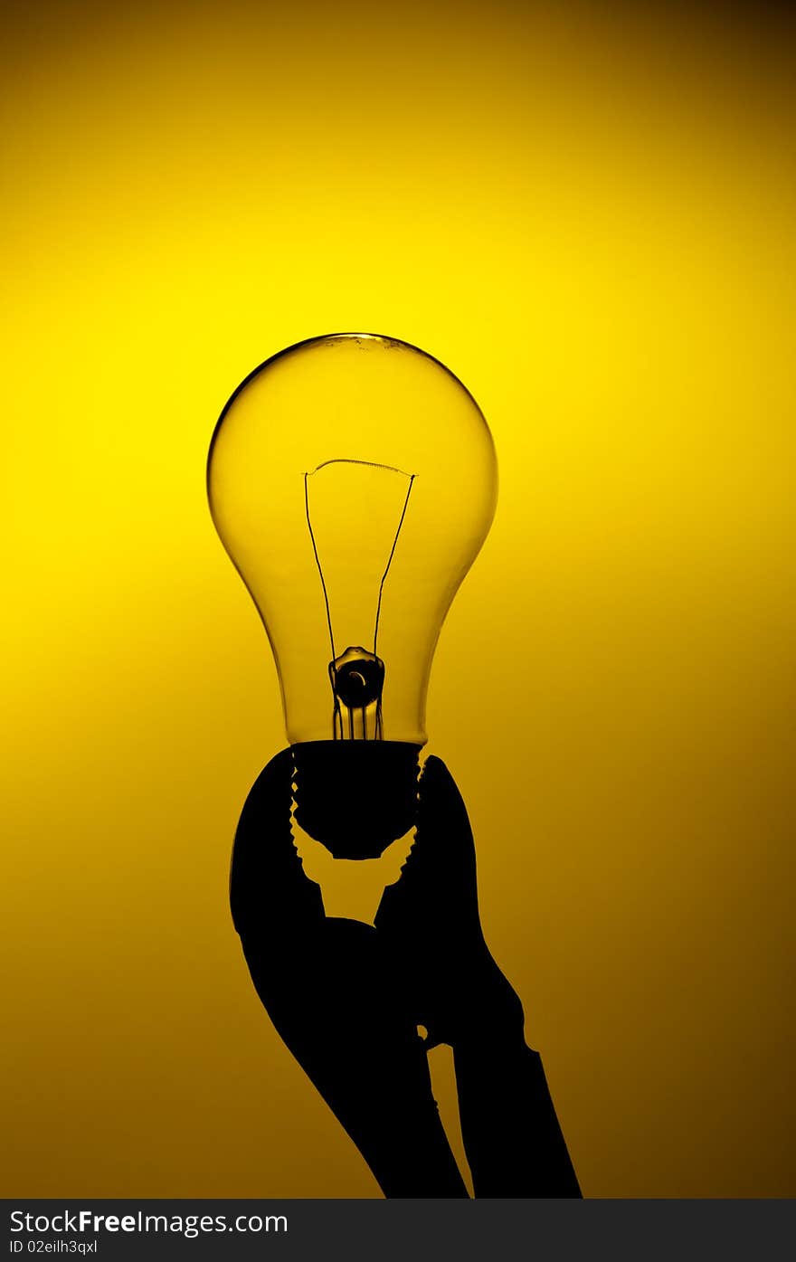 A light bulb held in a grip on a yellow gl