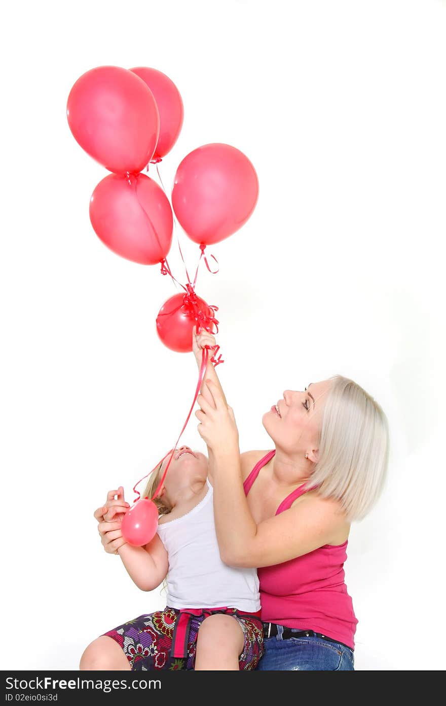 Mother and daughter with red balloons over white