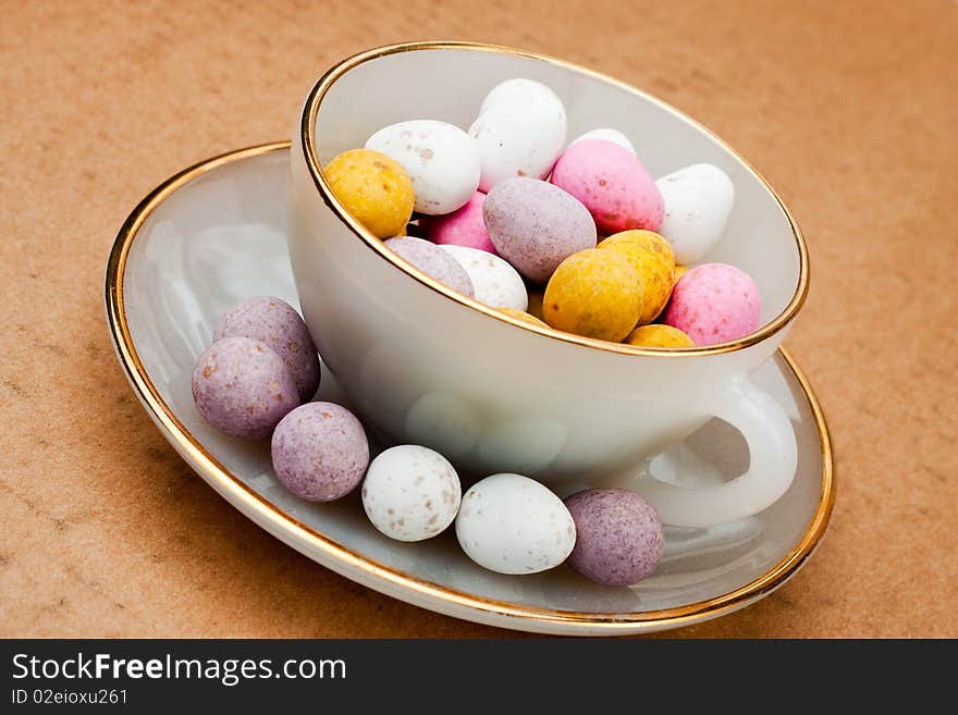 A china tea cup filled with chocolate easter eggs. A china tea cup filled with chocolate easter eggs