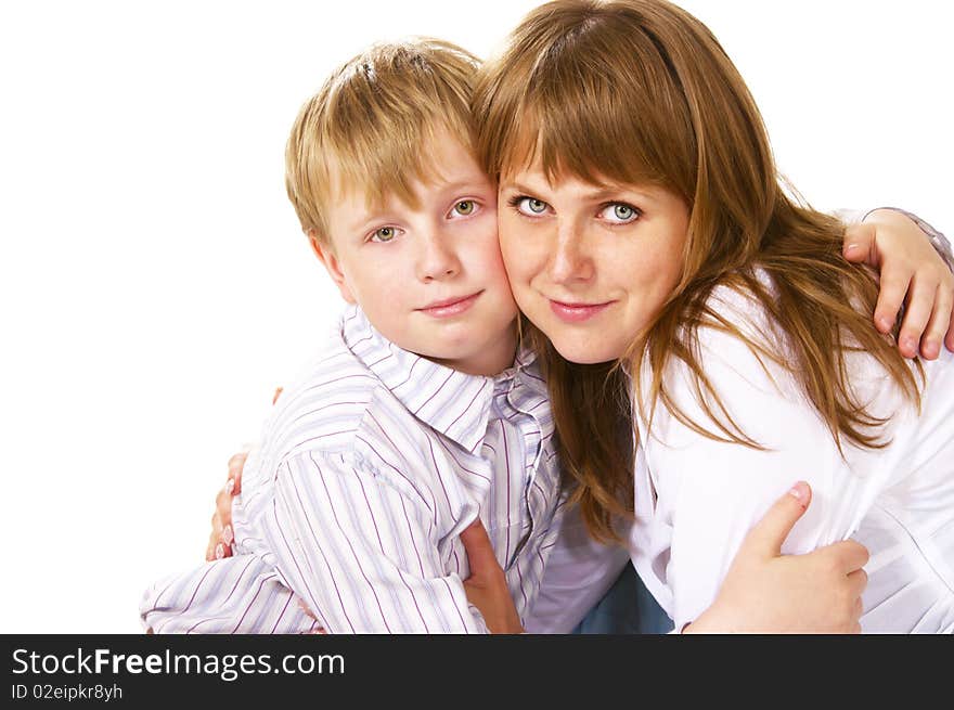 Tween boy hugging her mother over white