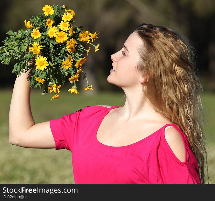 Beautiful young woman standing in blooming meadow