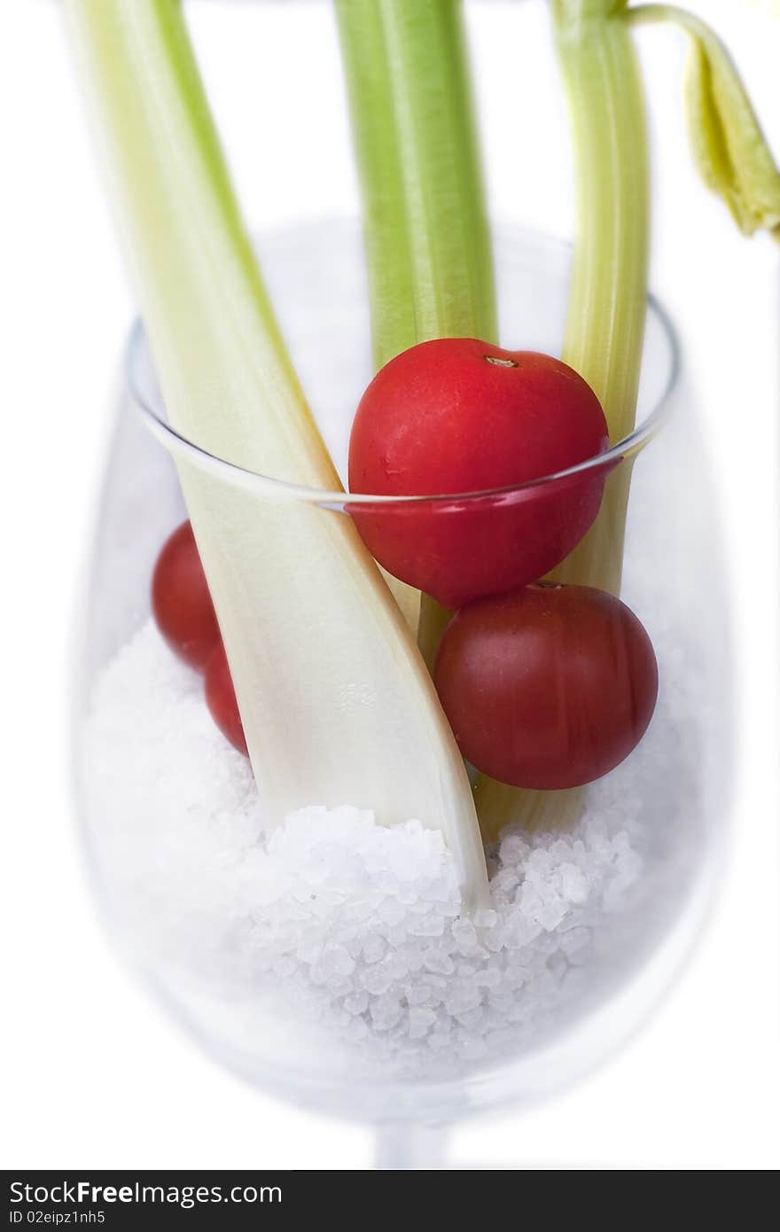 A stylish glass of celery and tomato with salt. A stylish glass of celery and tomato with salt