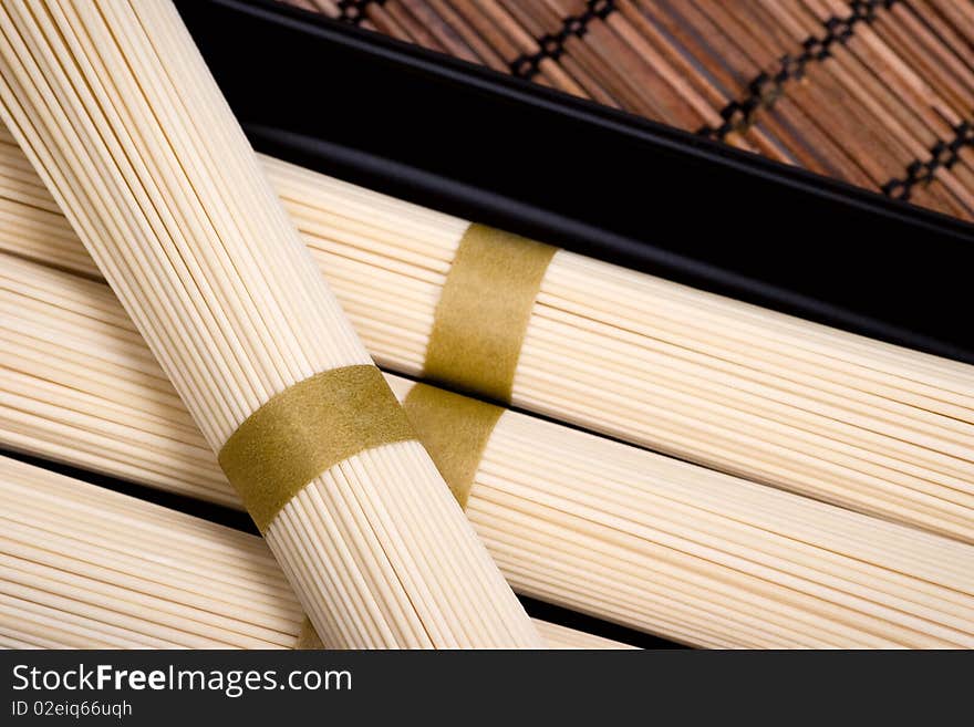 Unboiled oriental noodles on a rural mat. Selective focus. Unboiled oriental noodles on a rural mat. Selective focus.