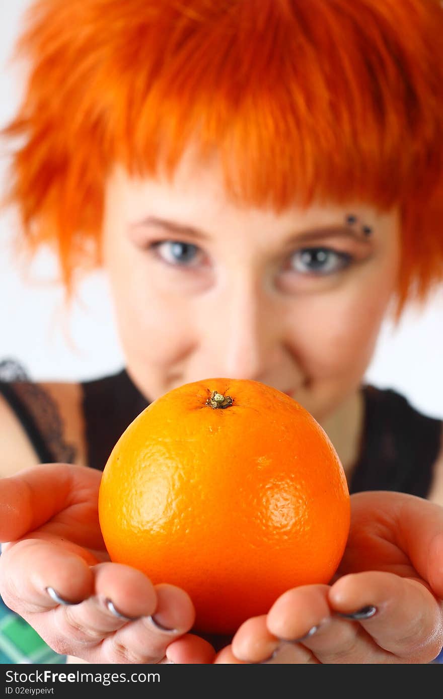 Girl with an orange on a white background