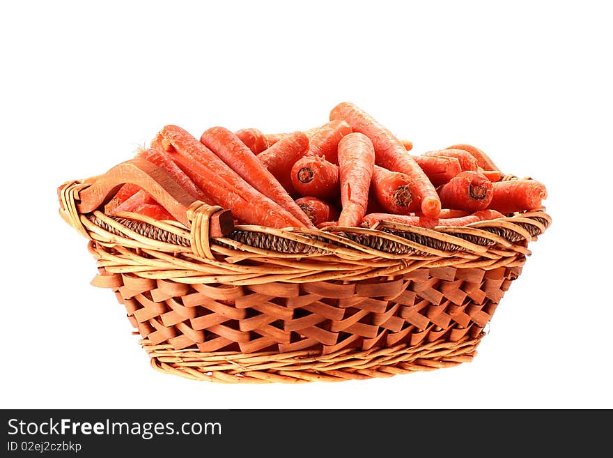 Carrot crop in a deep wattled basket on a white background.