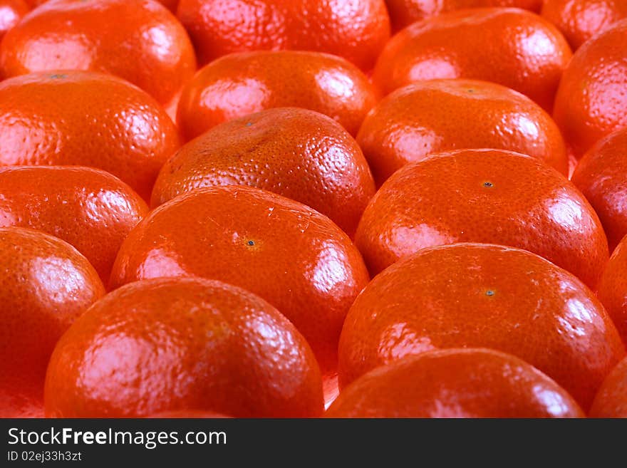 Tangerines are combined abreast and make a background.