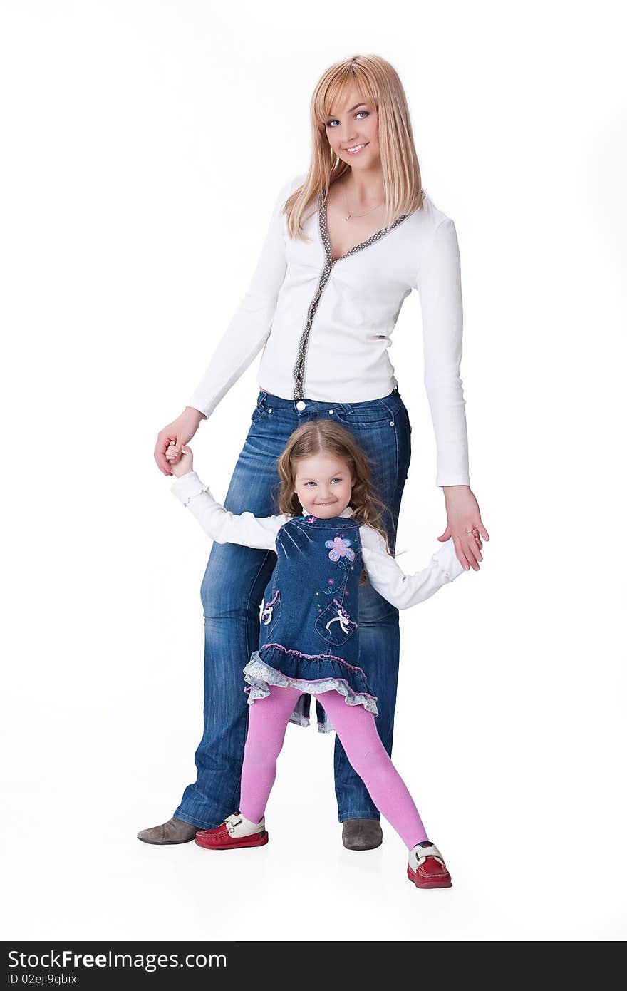 Young attractive blonde woman and little girl in fashinable clothing on isolated background. Young attractive blonde woman and little girl in fashinable clothing on isolated background