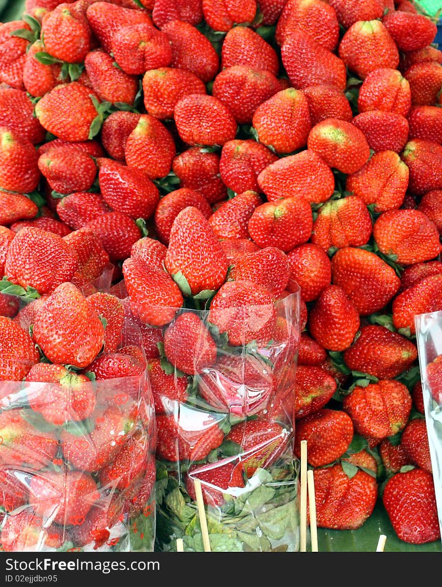 The juicy fresh strawberry is on sale on a tray